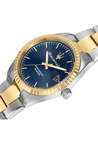 Silver and gold watch with a blue dial, gold hour markers, and a date window. Features a stainless steel and gold bracelet, water-resistant to 100 meters.