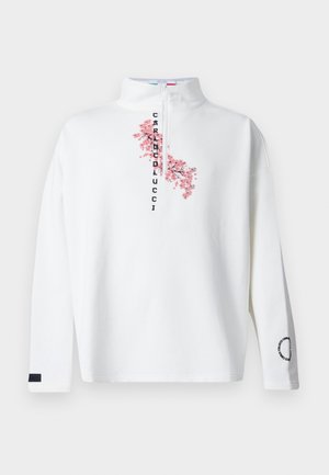 Pull blanc à manches longues avec une fermeture éclair devant, texte vertical "Carluccio" et motif de branche de fleur de cerisier rose sur la poitrine.