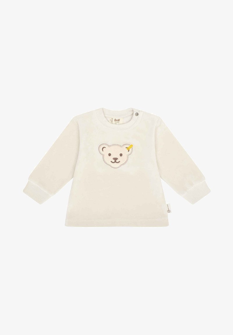 Chemise à manches longues crème en tissu doux, ornée d'un visage d'ours brodé avec des accents jaunes, et fermeture à boutons-pression à l'épaule.