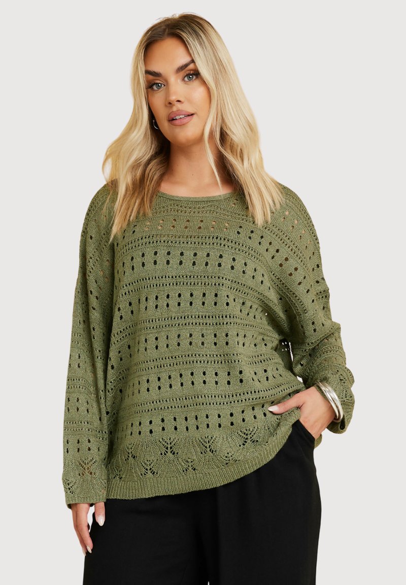 Olivgrön stickad tröja med en öppen vävstruktur med horisontella och vertikala linjer, långa ärmar och avslappnad passform.