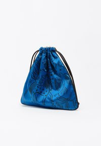 Bolsa de cordón de satén azul con dibujos en línea negra de animales y plantas. Presenta una parte superior recogida y correas de cordón negras.