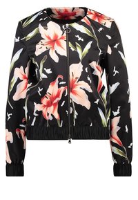 Veste bomber noire en tissu lisse ornée de grandes impressions florales roses et blanches. Fermeture éclair à l'avant, poignets et ourlet côtelés.