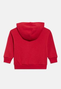 Červená mikina s dlouhým rukávem, žebrovanými manžetami a pasem, zobrazena zezadu na bílém pozadí.