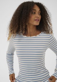 Blå og cremefarvet langærmet top med striber, ribbet tekstur og skålsyet halsudskæring, tætsiddende design og detalje ved håndleddet.