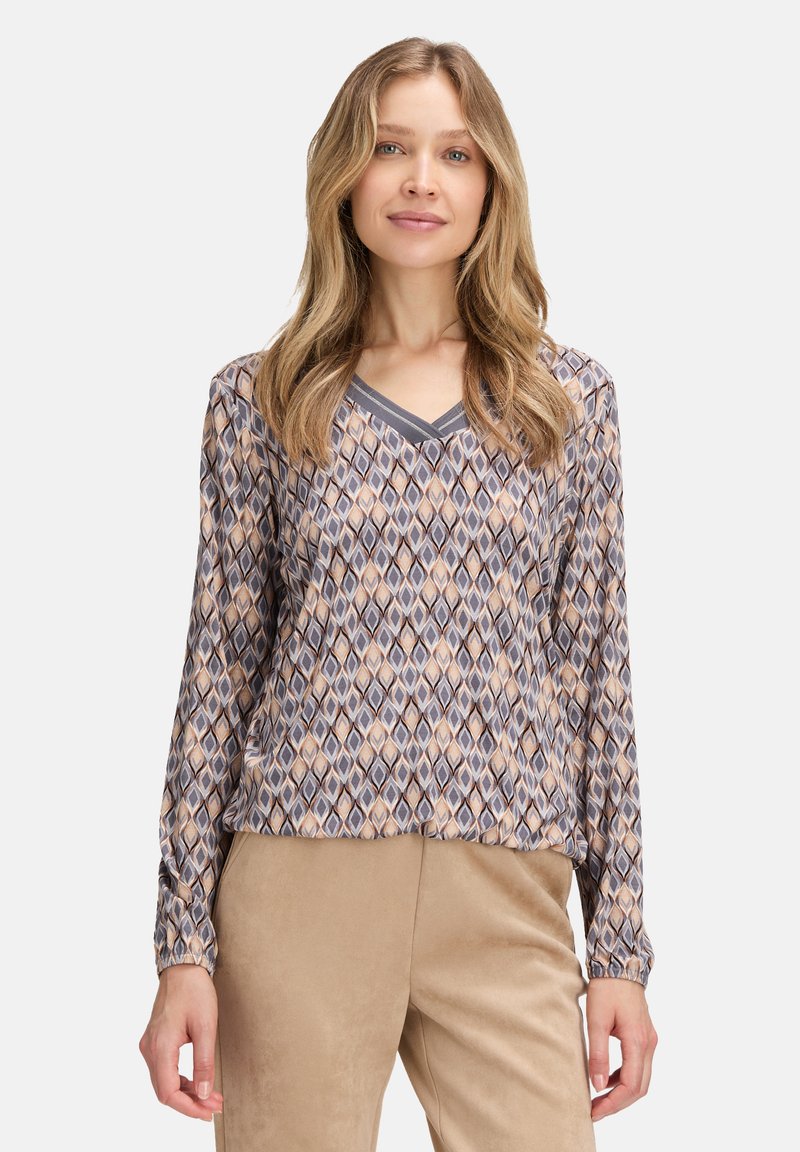 Long-sleeve blouse with a V-neck, featuring a geometric pattern in browns and blues, made of lightweight fabric, with gathered sleeves.