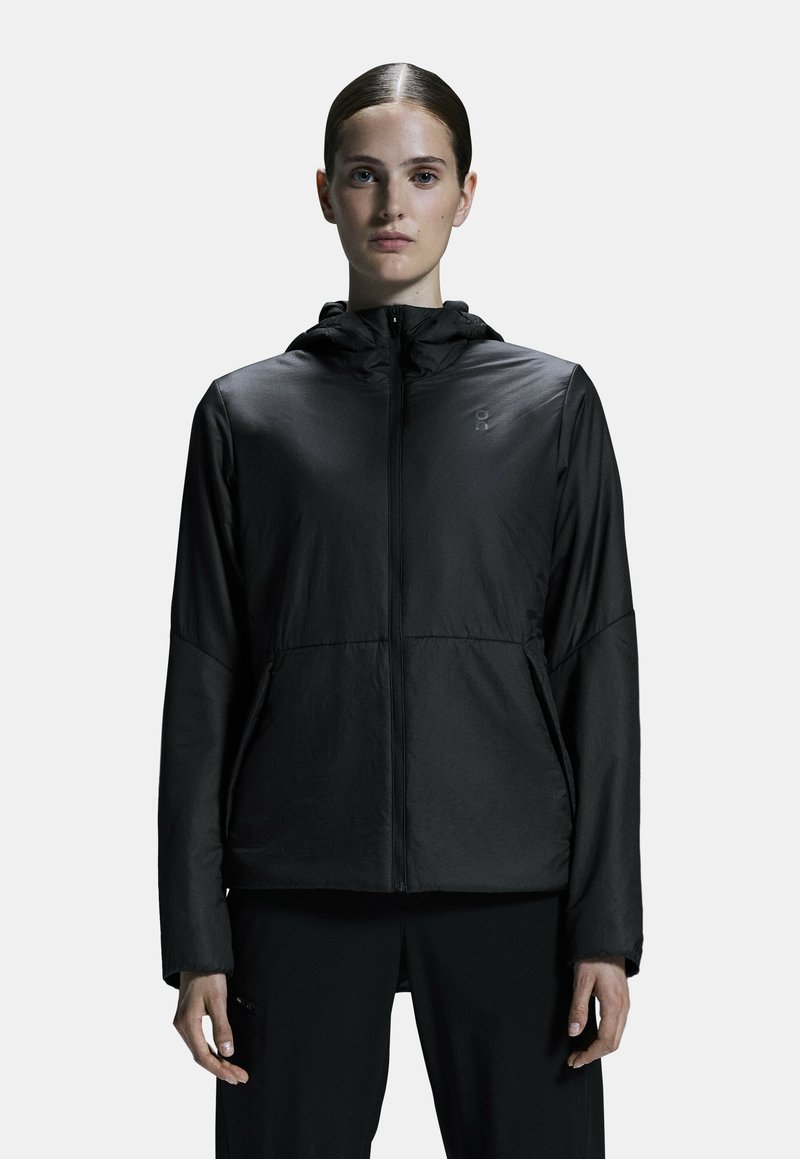 Black lightweight jacket with a zip front, attached hood, and two side pockets. Features a smooth texture and subtle logo on the chest.