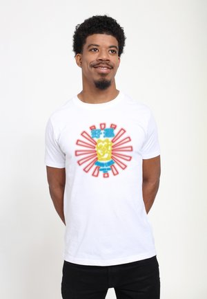 White t-shirt featuring a colorful graphic of a lucky cat surrounded by red rays and blue text, made of soft cotton fabric, short sleeves.