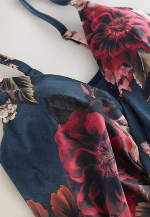 Lilleline mustriga rinnahoidja tumeda mereväe taustaga, kus on suured punased ja roosad lilled. Reguleeritavad rihmad ja pehme kangastekstuur.