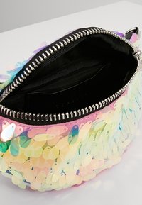 Bolso redondo con lentejuelas multicolores, que cuenta con un cierre de cremallera y forro de tela negra. Textura suave con una superficie brillante y reflectante.