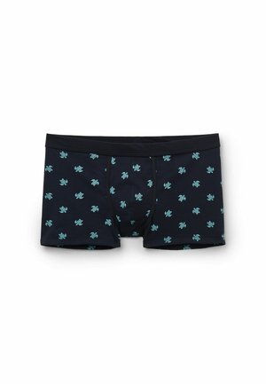 Schwarze Boxershorts mit kleinen blau-grünen Schildkrötenmustern, gleichmäßig über den Stoff verteilt, flach auf weißem Hintergrund.
