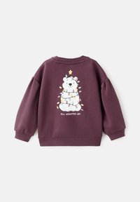 Maroon sweatshirt with long, puffed sleeves. Features a polar bear wrapped in colorful lights and a star, with the text "ALL WRAPPED UP!"