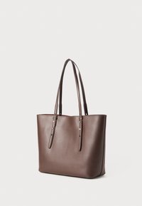 Brown leather tote bag with dual shoulder straps, rectangular shape, smooth texture, and minimalistic design. No visible patterns or hardware.