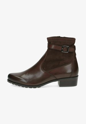 Brown ankle boot made of smooth leather and suede. Features a side zipper and buckle strap, with a textured outsole and a low block heel.