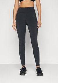 Leggings neri realizzati in tessuto elasticizzato con vita alta, caratterizzati da un logo discreto sulla coscia sinistra e una superficie liscia.