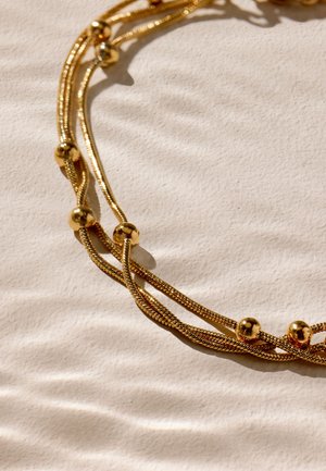 Next, Armband - gold tone