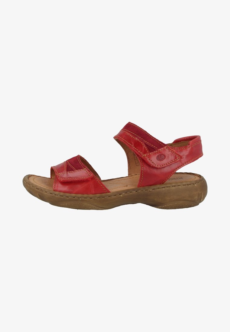 Red leather sandals with two adjustable straps, a cushioned footbed, and a tan rubber sole. Features stitched accents and a rounded toe design.
