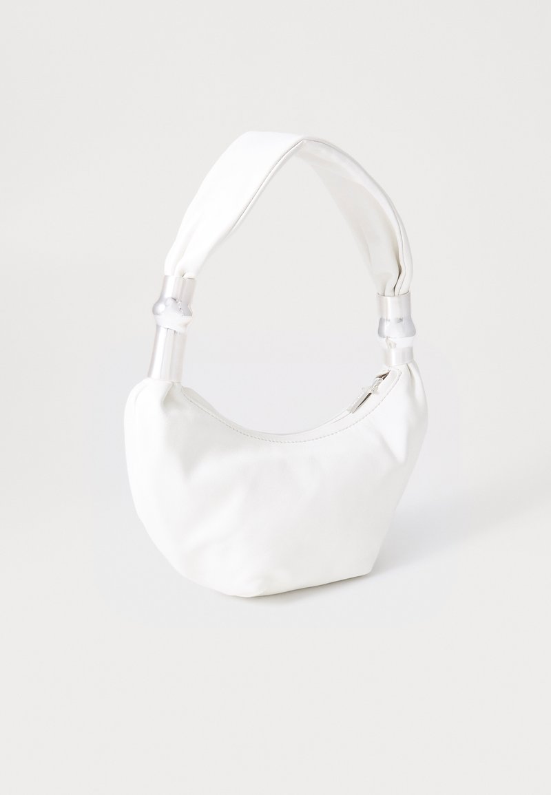 White leather handbag with padded top handle featuring transparent plastic accents and a zipper closure on the top.