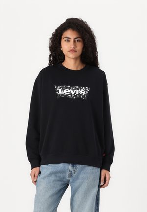 Black cotton sweatshirt with a crew neck, featuring a white, star-patterned Levi's logo across the chest. Loose fit with ribbed cuffs.