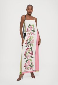 Maxi dress featuring a white base with pink, green, and purple floral embroidery. Designed with thin straps and a straight silhouette.
