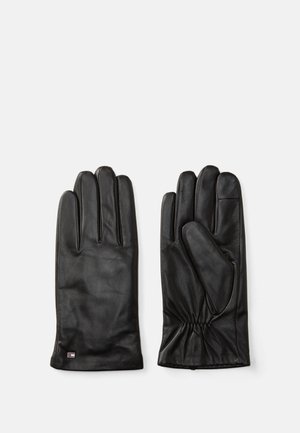 Gants en cuir noir au toucher lisse, design à cinq doigts et détail froncé au poignet. Petit logo de marque sur le poignet.