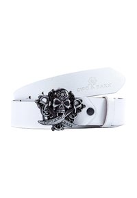 Ceinture en cuir blanche avec une boucle en forme de crâne et de tibias noirs, dotée de détails complexes. Logo gravé sur la sangle de la ceinture.