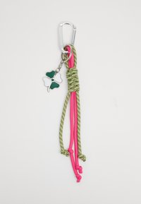 Keychain with a silver carabiner, green and pink braided cord, and a green and white clover charm. Textured with knots and patterns.