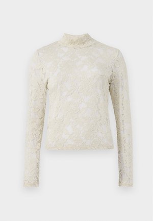 Cream-colored lace top with a high neckline, long sleeves, and floral pattern, featuring a fitted silhouette and textured finish.