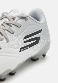 Gray football boots made of synthetic material with textured upper, black logo, and a gradient design pattern. Features molded studs for traction.