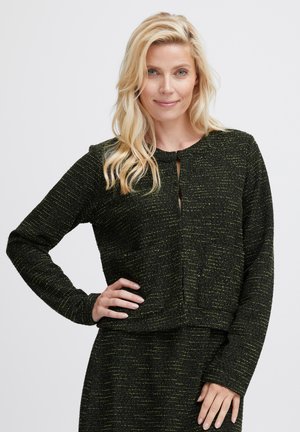 Haut en tricot texturé noir et vert avec des manches longues, un col rond et un détail en trou de serrure à l'avant. Présente une silhouette cropped et un tissu doux.