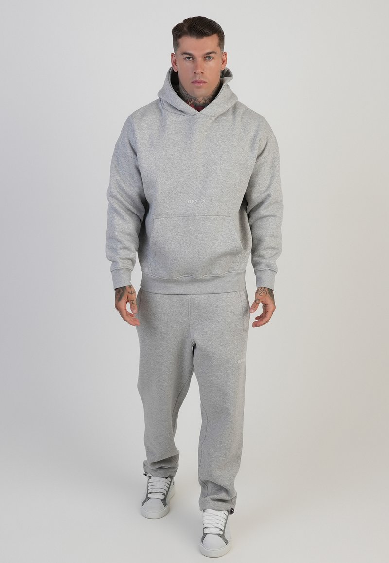Grau Hoodie- und Jogginghosen-Set aus weichem Stoff, mit einer Kängurutasche, gerippten Bündchen und dem Markenlogo auf der Brust und dem Bein.