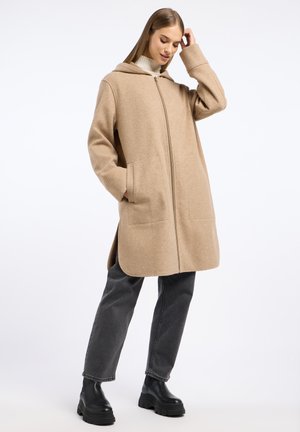 Beige wollenblend jas met een capuchon, voorrits en twee grote zakken. Heeft een losse pasvorm en zijsplitten voor bewegingsgemak.