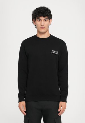 Black cotton sweatshirt with long sleeves, crew neck, and "Versace Couture" logo in white on the left chest. Smooth texture.