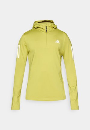 Light green long-sleeve hoodie with a half-zip, featuring white stripes on sleeves and a logo on the chest. Textured stretch fabric.