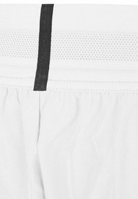 Hvite treningsshorts med en teksturert midje hvor det er en svart dekorstrip og horisontale linjer, laget av lettvektsstoff.