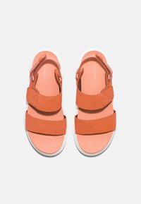 Orange suede sandals featuring two wide straps, a textured upper, and a white rubber sole. Logo embossed on the footbed.