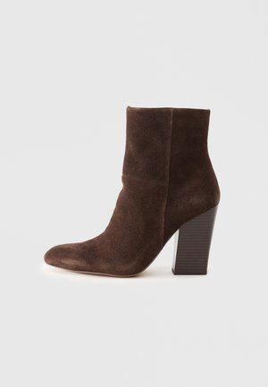 Brown suede ankle boot with a pointed toe and a high, textured block heel. Features a smooth upper and fitted silhouette.