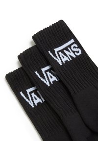 Sorte sokker lavet af strikket materiale, med et hvidt "VANS" logo. Foran har de ribbede skaft og er i en klassisk crew sock-form.