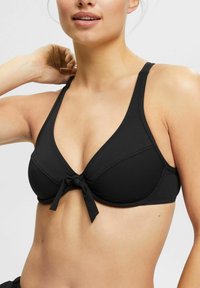 Sort bikini top med trekantet form, struktureret materiale og en frontsløjfe. Har brede stropper og et glat, sømløst design.