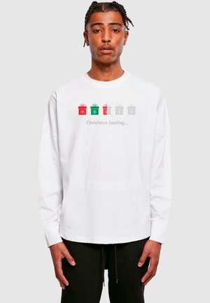White long-sleeve shirt featuring a central graphic of five colored gift boxes (red, green, gray) with text "Christmas loading..." below.