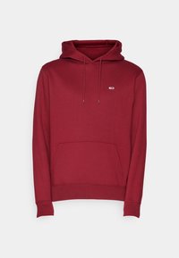Sudadera de algodón roja con un bolsillo frontal, capucha con cordón y un pequeño logo en el pecho. Presenta puños y dobladillo acanalados.