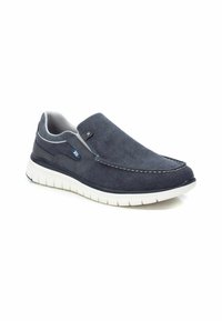 Zapatos de lona azul marino tipo slip-on con suela de goma. Presentan detalles de costura, paneles laterales elásticos y una suela blanca en contraste.