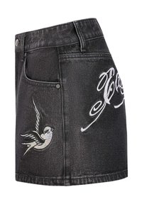 Black denim mini skirt with a fitted shape, featuring white embroidered bird and script designs, metal buttons, and classic pockets.