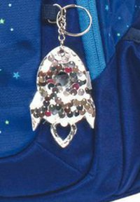 Portachiavi a forma di razzo argentato con paillettes colorate, dotato di un foro circolare al centro, attaccato a uno zaino blu.