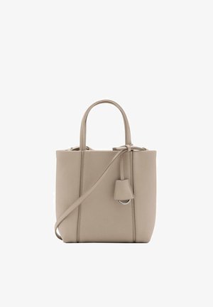 Borsa a mano in pelle beige con due manici corti, tracolla regolabile e piccola targhetta attaccata. Texture liscia, forma rettangolare, design minimalista.