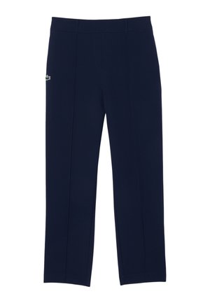 Pantaloni blu navy realizzati in tessuto liscio, con un design elegante caratterizzato da pieghe frontali e un piccolo logo sul fianco sinistro.