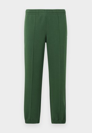 Green sweatpants made of soft fabric; features an elastic waistband, tapered legs, and a small logo on the side.