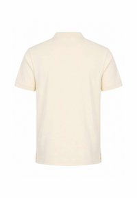 Polo uni beige clair à manches courtes, vu de dos avec un col et des fentes latérales à l'ourlet.