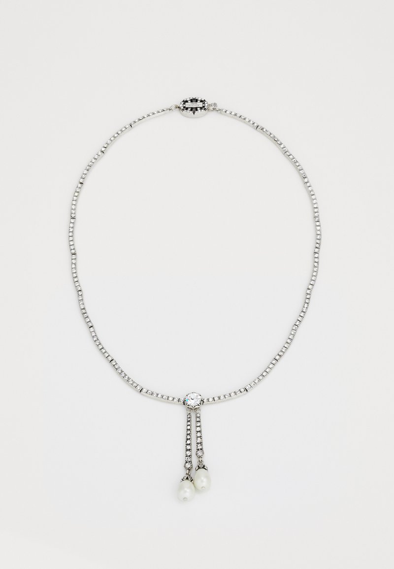 Silver-tone necklace featuring clear stones, with two dangling white pearls and an ornate clasp design. Structured, with a textured link chain.