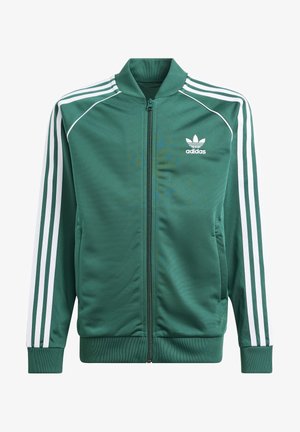 Veste de survêtement Adidas verte zippée avec trois bandes blanches sur les manches et logo trèfle Adidas sur la poitrine.