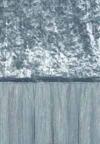 Textured light blue fabric with a plush, velvety top and pleated, metallic-threaded lower section, creating contrast in material and sheen.